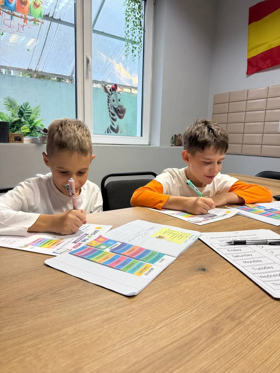 Двоє хлопчиків виконують завдання на дні тижня англійською